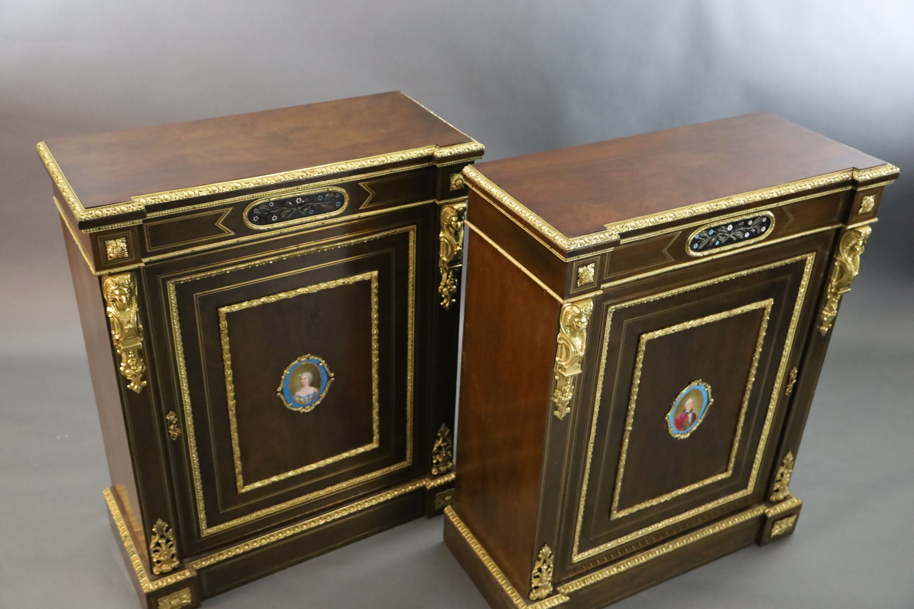 A pair of 19th century French ormolu mounted walnut pier cabinets, W.2ft 11in. D.1ft 4in. H.3ft 7in.